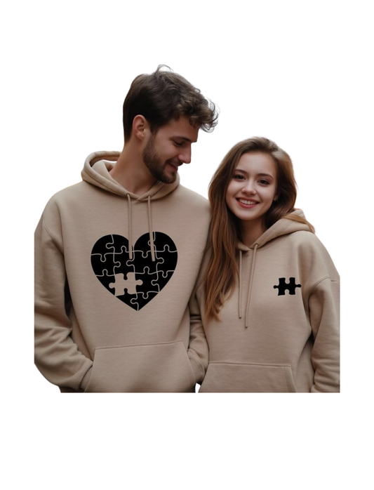 Two people wearing beige hoodies with unique designs on a white background