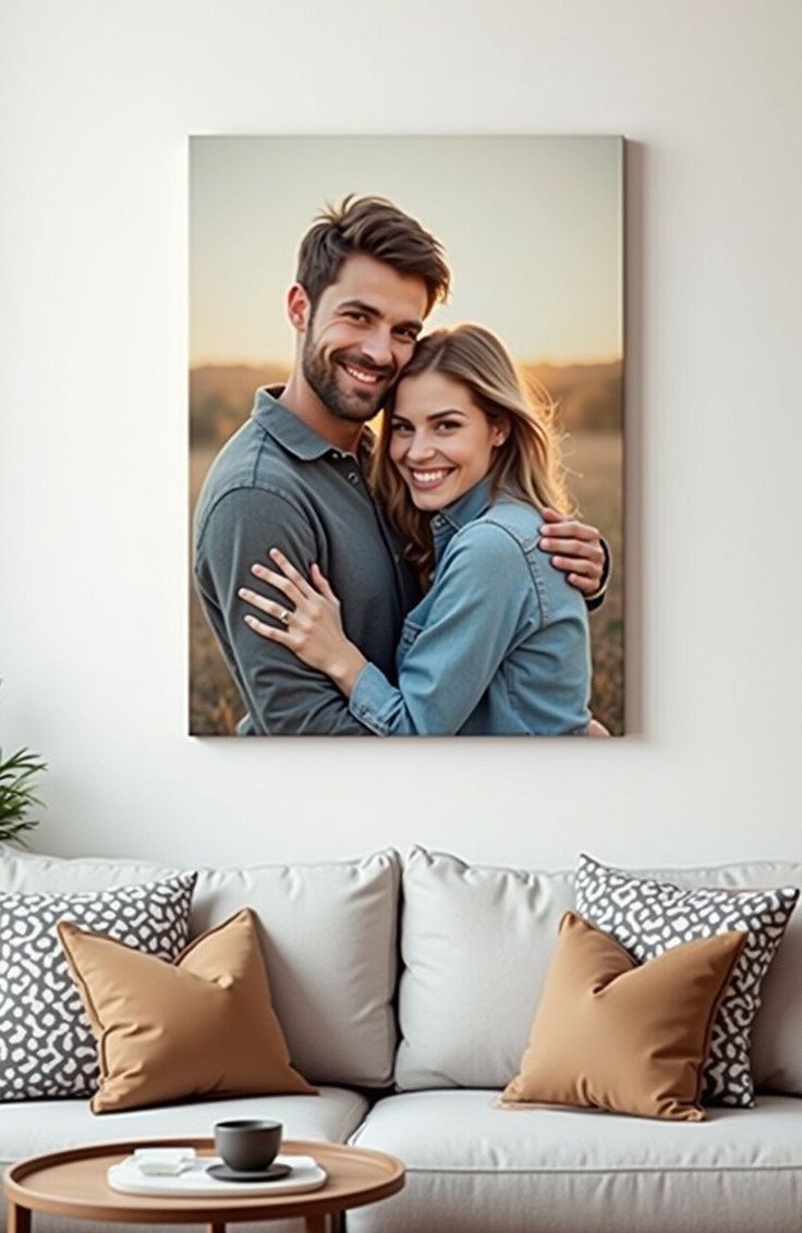 Canvas print of a couple hugging on a wall above a sofa with decorative pillows.