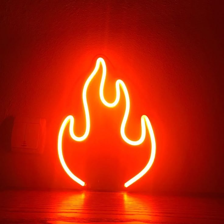 Neon flame-shaped light on a red background